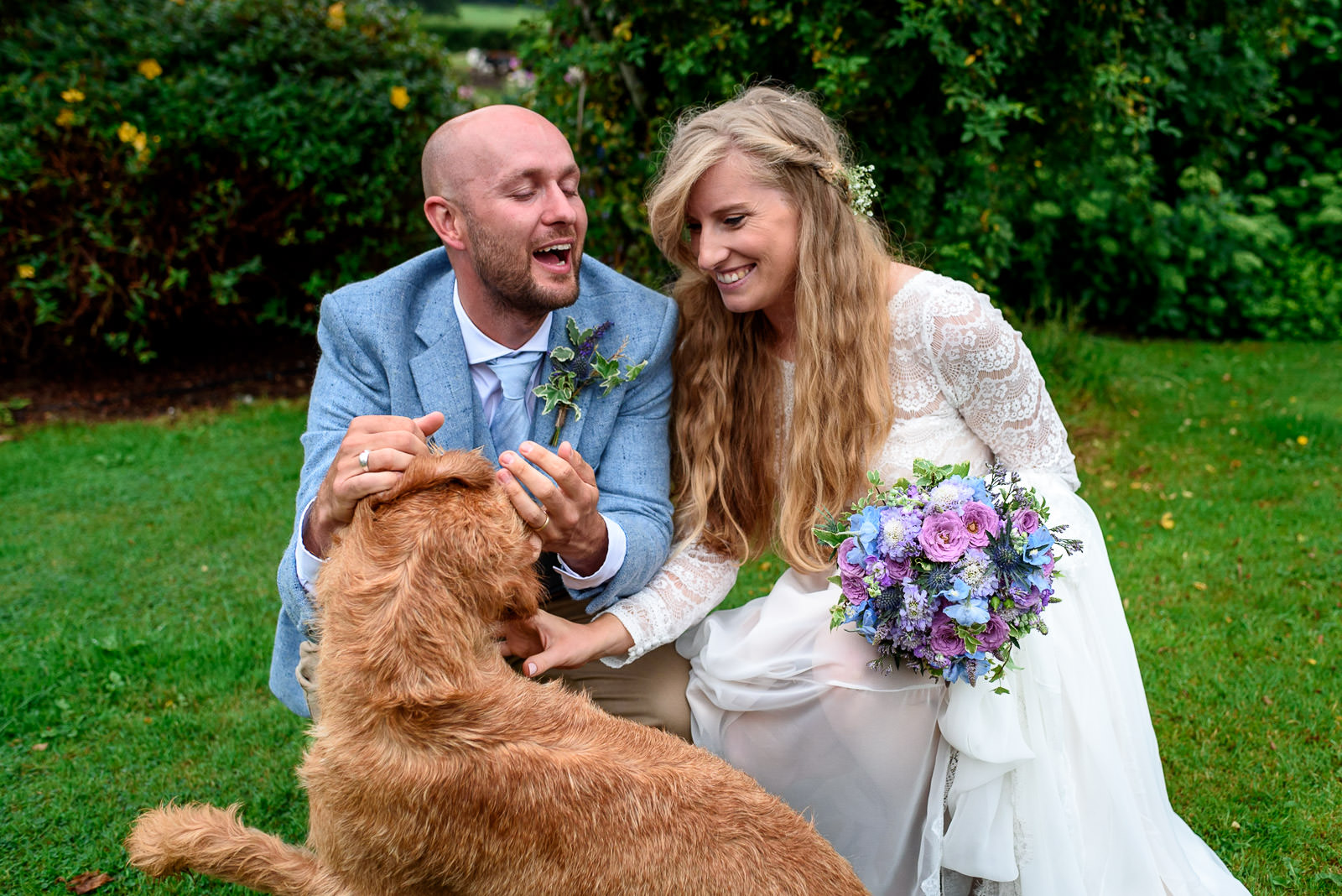 Wedding couple taking photos with their dog