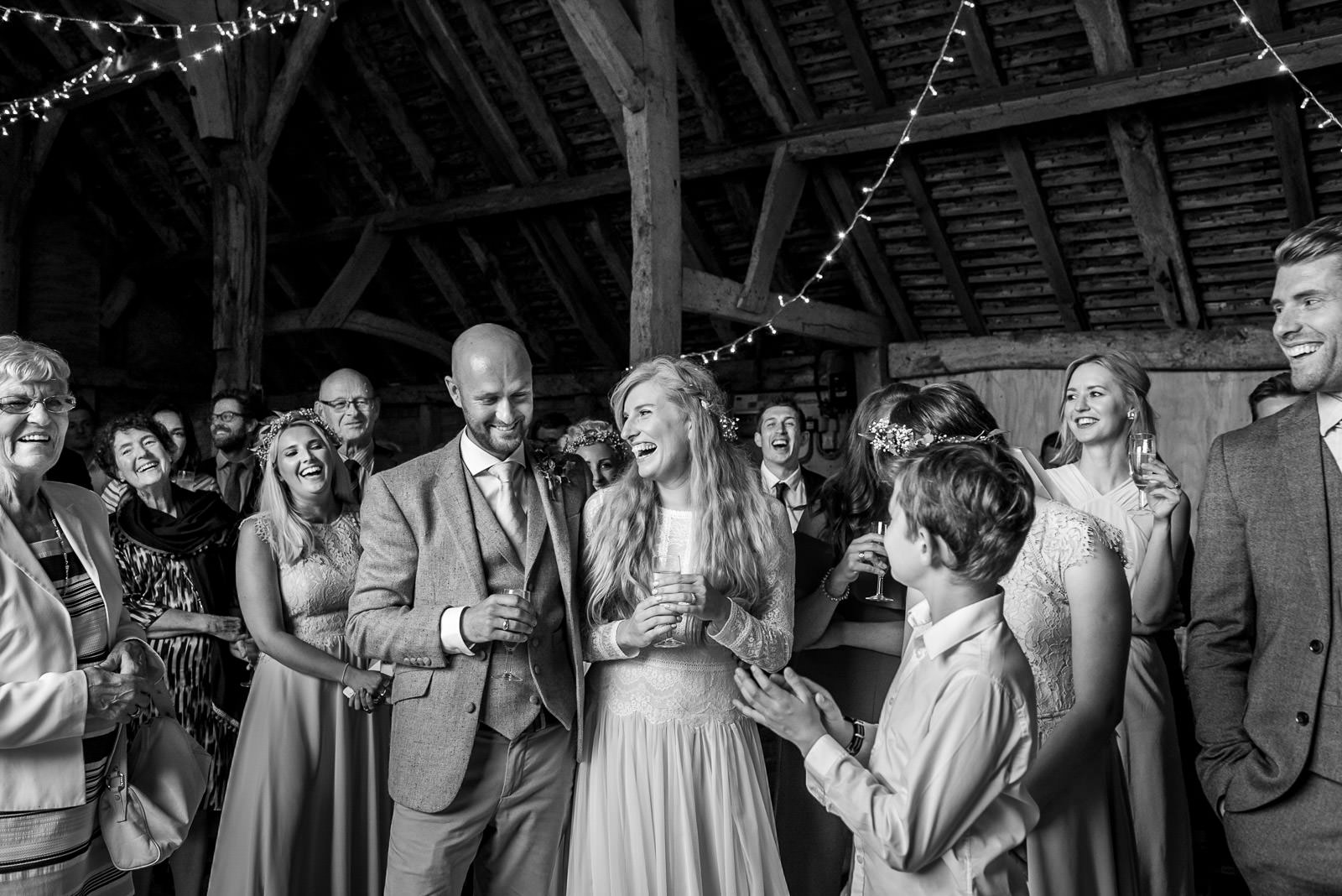 bride and groom laughing during wedding speeches