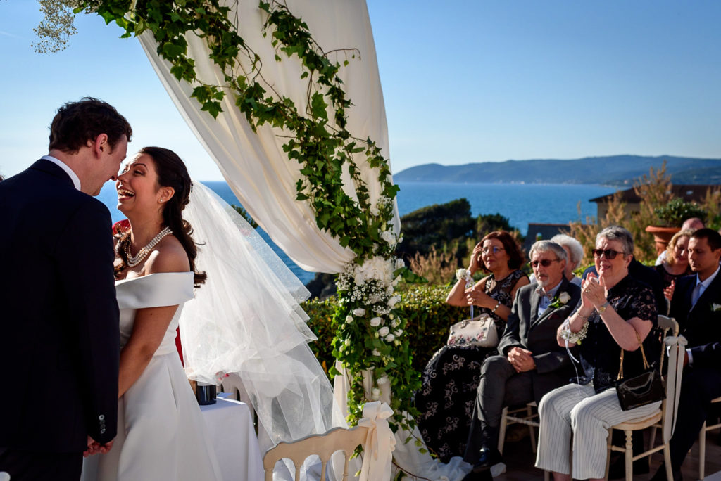 couple laughing during wedding ceremony at Villa Parisi in Castiglioncello