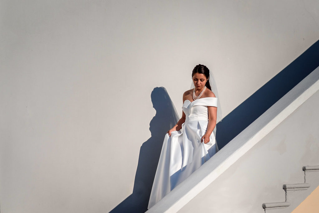 Bride walking down the stairs for her wedding at Villa Parisi in Castiglioncello Italy