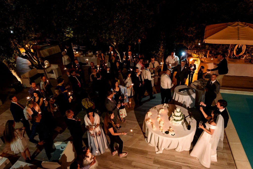 wedding couple cutting their cake at Villa Parisi in Castiglioncello