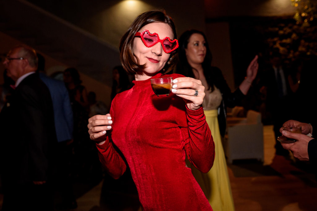 girl dancing with espresso shot at a wedding in Italy