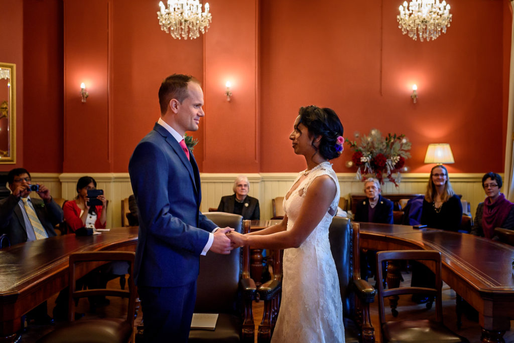 Bride and groom exchanging rings at Brighton town hall