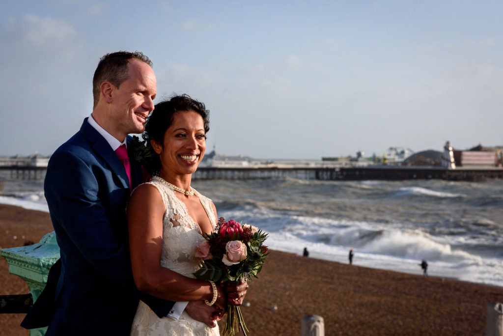 wedding couple posing with Brighton sea and Brighton Pavilion